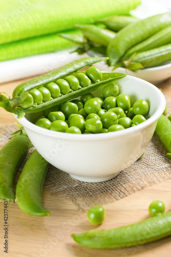 Photo: Fresh green peas on the white bowl Fresh green peas on the white bowl