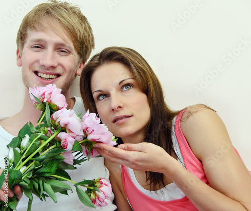 Photo: Young couple in love with Peonies Young couple in love with Peonies