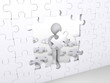Person holding puzzle piece about to complete vertical puzzle