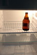 last beer bottle in an empty fridge