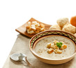 Soup and ingredients on the tablecloth, isolated on white