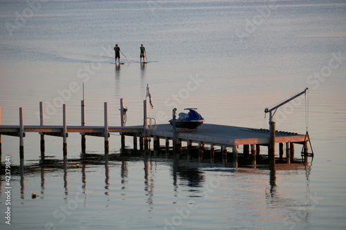 Photo: paddle boarders at dusk paddle boarders at dusk