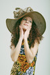 Photo: Frizzy girl in a hat. Frizzy girl in a hat.