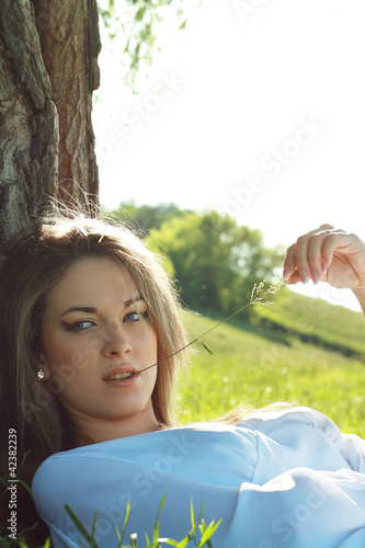 Photo: woman laying under the tree woman laying under the tree