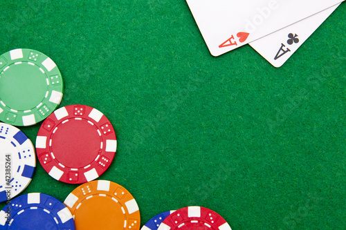 Photo: Texas holdem pocket aces on casino table with copy space and chi Texas holdem pocket aces on casino table with copy space and chi