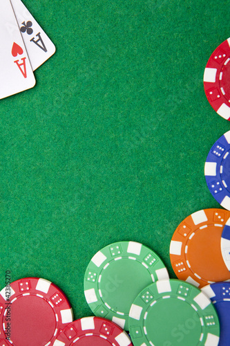 Photo: Texas holdem pocket aces on casino table with copy space and chi Texas holdem pocket aces on casino table with copy space and chi