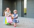 Fashion-monger baby on shopping with mom wear new glasses