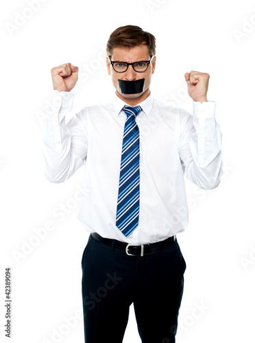Photo: Angry young man with duct tape on his mouth Angry young man with duct tape on his mouth