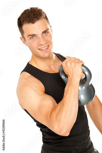 Photo: Muscular man lifting dumbbell and looking in camera Muscular man lifting dumbbell and looking in camera