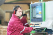 Photo: Portrait of carpentry worker with CNC machine Portrait of carpentry worker with CNC machine