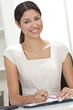 Hispanic Latina Woman or Businesswoman in Office Writing