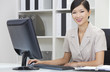 Asian Chinese Woman or Businesswoman Using Computer In Office