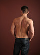 Shirtless man in blue jeans