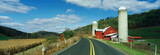 Photo: This is a country road with a farm on the right hand side of the road. It has a red barn and silo. This is a country road with a farm on the right hand side of the road. It has a red barn and silo.