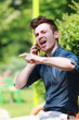 Photo: Young man in the park talk on telephone Young man in the park talk on telephone