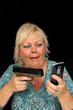 Photo: Mature Blonde Woman with Cell Phone and a Handgun (2) Mature Blonde Woman with Cell Phone and a Handgun (2)