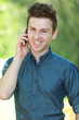 Photo: Portrait of handsome man with telephone in park Portrait of handsome man with telephone in park