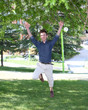 Photo: Happy and jumping young man in park Happy and jumping young man in park