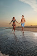 happy couple enjoying vacations on the beach