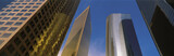 Photo: This is a view looking up at the office towers in Los Angeles. Light glistens on the side of the buildings. This is a view looking up at the office towers in Los Angeles. Light glistens on the side of the buildings.