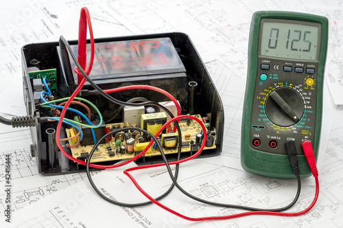 Photo: Testing old battery voltage with digital multimeter Testing old battery voltage with digital multimeter