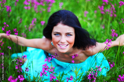 Foto: woman on summer flower field woman on summer flower field