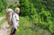 Foto: woman tourist on forest road woman tourist on forest road