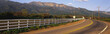Photo: This is scenic Route 150 with the Topa Topa Mountains in the background. The road curves and there is a white fence along the left hand side of the road marking the nearby ranch property. This area is known as upper Ojai. This is scenic Route 150 with the Topa Topa Mountains in the background. The road curves and there is a white fence along the left hand side of the road marking the nearby ranch property. This area is known as upper Ojai.