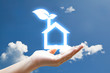 Hand and vivid eco houes icon on sky