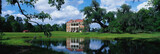 Photo: This is a southern plantation called Drayton Hall. It is a pre-Revolutionary plantation set on the Ashley River. It has Georgian Palladian architecture and was built from 1738-1742. It is set back on a green lawn with a pond showing the reflection of the plantation in the water. This is a southern plantation called Drayton Hall. It is a pre-Revolutionary plantation set on the Ashley River. It has Georgian Palladian architecture and was built from 1738-1742. It is set back on a green lawn with a pond showing the reflection of the plantation in the water.