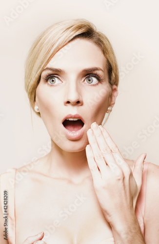 Photo: Toned portrait of woman reacting in horror Toned portrait of woman reacting in horror