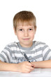 The little boy writes to writing-books a ball pen