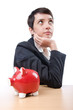 Woman and piggybank on white