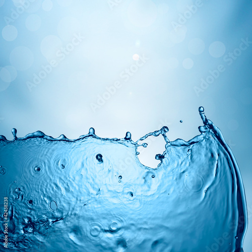 Photo: Water splash on blue natural background Water splash on blue natural background