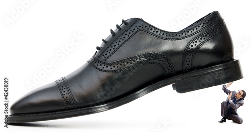 Foto: Woman domination concept with shoes and man Woman domination concept with shoes and man