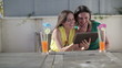 Video: Two female friends using tablet computer, outdoors, tracking Two female friends using tablet computer, outdoors, tracking