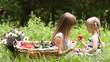 Family with vegetables in nature. They eat tomatoes
