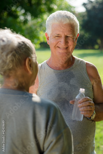 Photo: Seniors drinking water after fitness in park Seniors drinking water after fitness in park