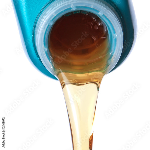 Photo: Flowing lubricating oil. Closeup. Flowing lubricating oil. Closeup.