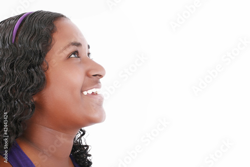 Photo: Happy african girl looking up, isolated on white Happy african girl looking up, isolated on white