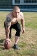 A male football player is ready to play the game