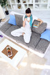 Photo: Relaxation woman with tea and book in living room Relaxation woman with tea and book in living room
