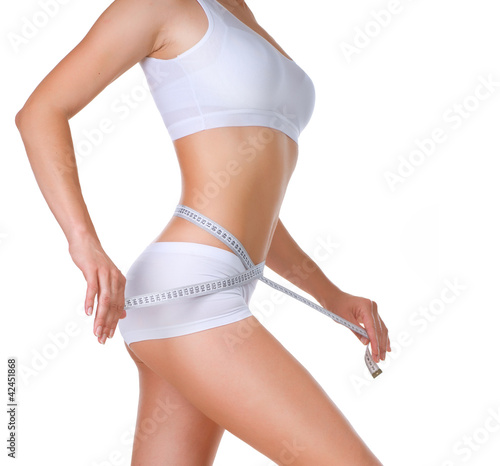 Photo: Woman measuring her waistline. Perfect Slim Body Woman measuring her waistline. Perfect Slim Body