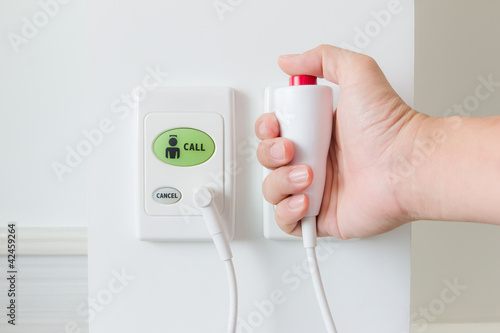 Photo: hand pushing nurse call button hand pushing nurse call button