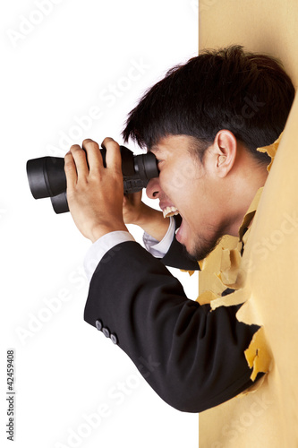 Photo: Shocked businessman looking with binoculars Shocked businessman looking with binoculars