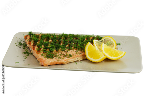 Photo: Grilled salmon fish fillet with dill and lemon on grey ceramic d Grilled salmon fish fillet with dill and lemon on grey ceramic d