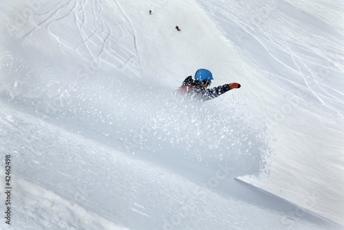 Photo: Snowboarder moving down Snowboarder moving down