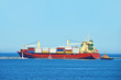 Tugboat assisting cargo ship over lighthouse in Odessa, Ukraine