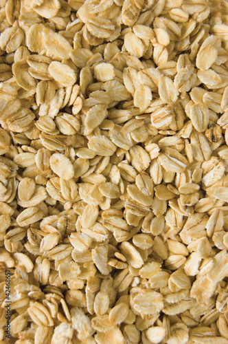 Photo: Oatmeal background, rolled raw oats macro closeup vertical Oatmeal background, rolled raw oats macro closeup vertical
