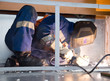 Photo: Welder working in cramped conditions Welder working in cramped conditions